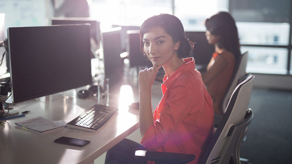 Female executive sitting at desk in office